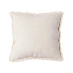 Beige cushion by SKAY on a soft surface, showcasing its fabric texture and square shape, perfect for home decor.