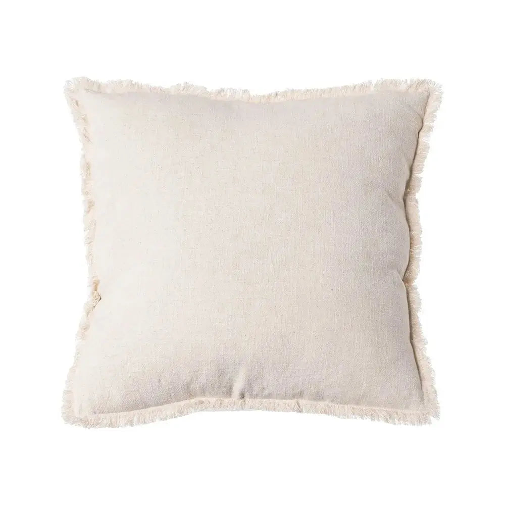 Beige cushion by SKAY on a soft surface, showcasing its fabric texture and square shape, perfect for home decor.