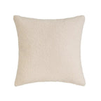 Soft SKAY sherpa bouclé cushion in a cozy texture, showcasing its plush surface and neutral color.