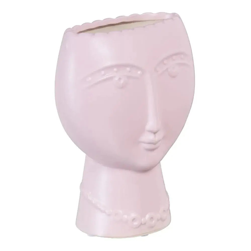 Ceramic face planter in malva color by SKAY, showcasing a unique design perfect for indoor plants.