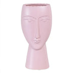 Ceramic face planter in malva color by SKAY, featuring a unique facial design and suitable for indoor plants.