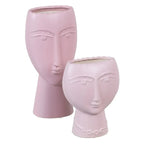 Ceramic face planter in mauve from SKAY, featuring a unique design and perfect for indoor plants.