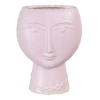 Ceramic face planter in malva color by SKAY, featuring a whimsical design with a smiling face.