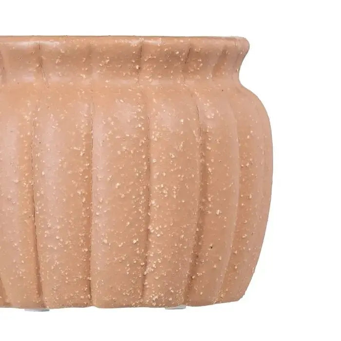 Ceramic salmon-colored planter by SKAY, showcasing a smooth finish and modern design for indoor plants.