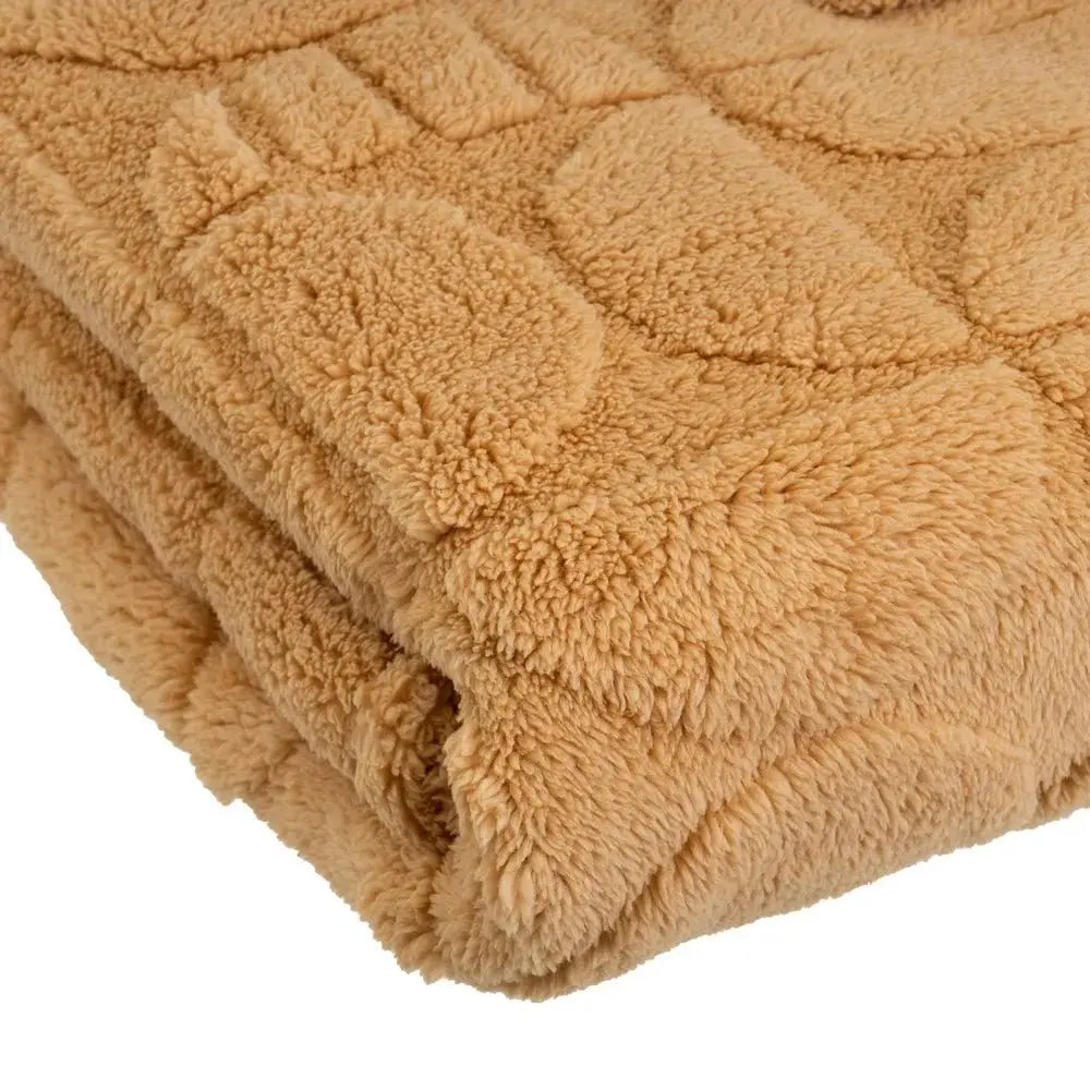 Soft SKAY jacquard blanket featuring intricate patterns and a cozy texture, perfect for layering on a bed or couch.