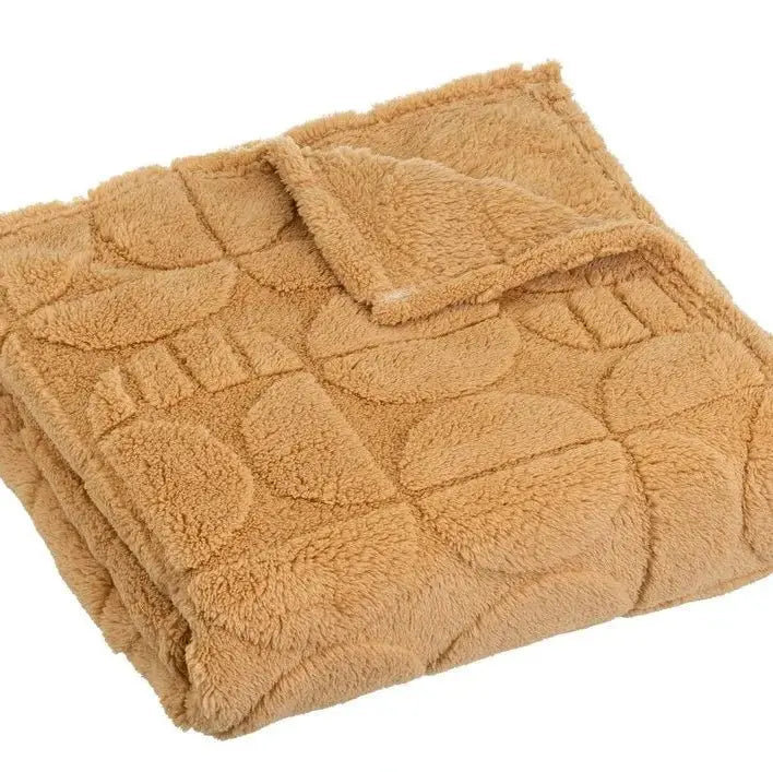 Cozy SKAY jacquard blanket with intricate patterns, showcasing its soft texture and elegant design.