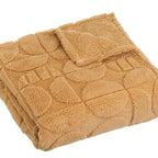 Cozy SKAY jacquard blanket with intricate patterns, showcasing its soft texture and elegant design.