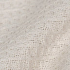 Cream cotton plaid blanket from SKAY featuring a textured honeycomb pattern.