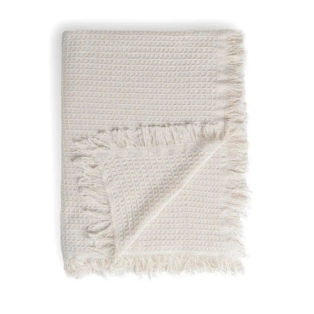Cream cotton plaid blanket from SKAY, featuring a textured honeycomb pattern for cozy warmth and style.